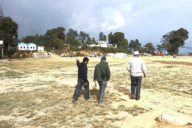 Sindhu radio manager showing the field where 500 of Chautara's inhabitants stayed for weeks after the earthquake. Sindhu broadcast from here for months until it moved into its new building in November. Photo: Andreas Sugar, IMS